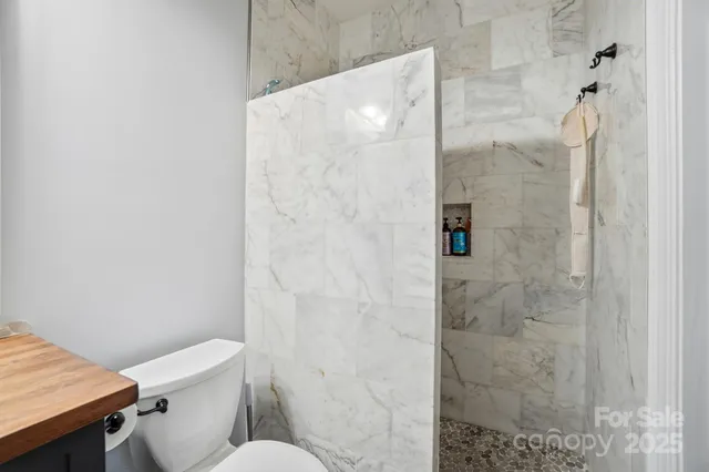 a white toilet sitting next to a bathroom sink