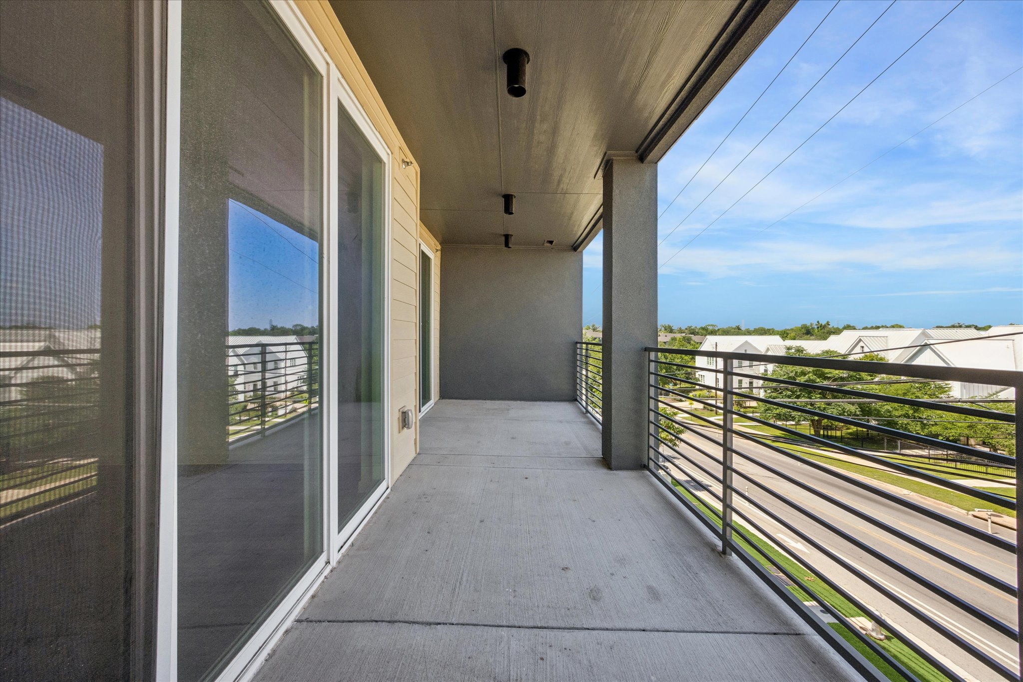 4801 Springdale Road, Unit 2210 Austin, TX 78723 - Photo 12 of 14 The balcony is accessible through the living area and primary bedroom