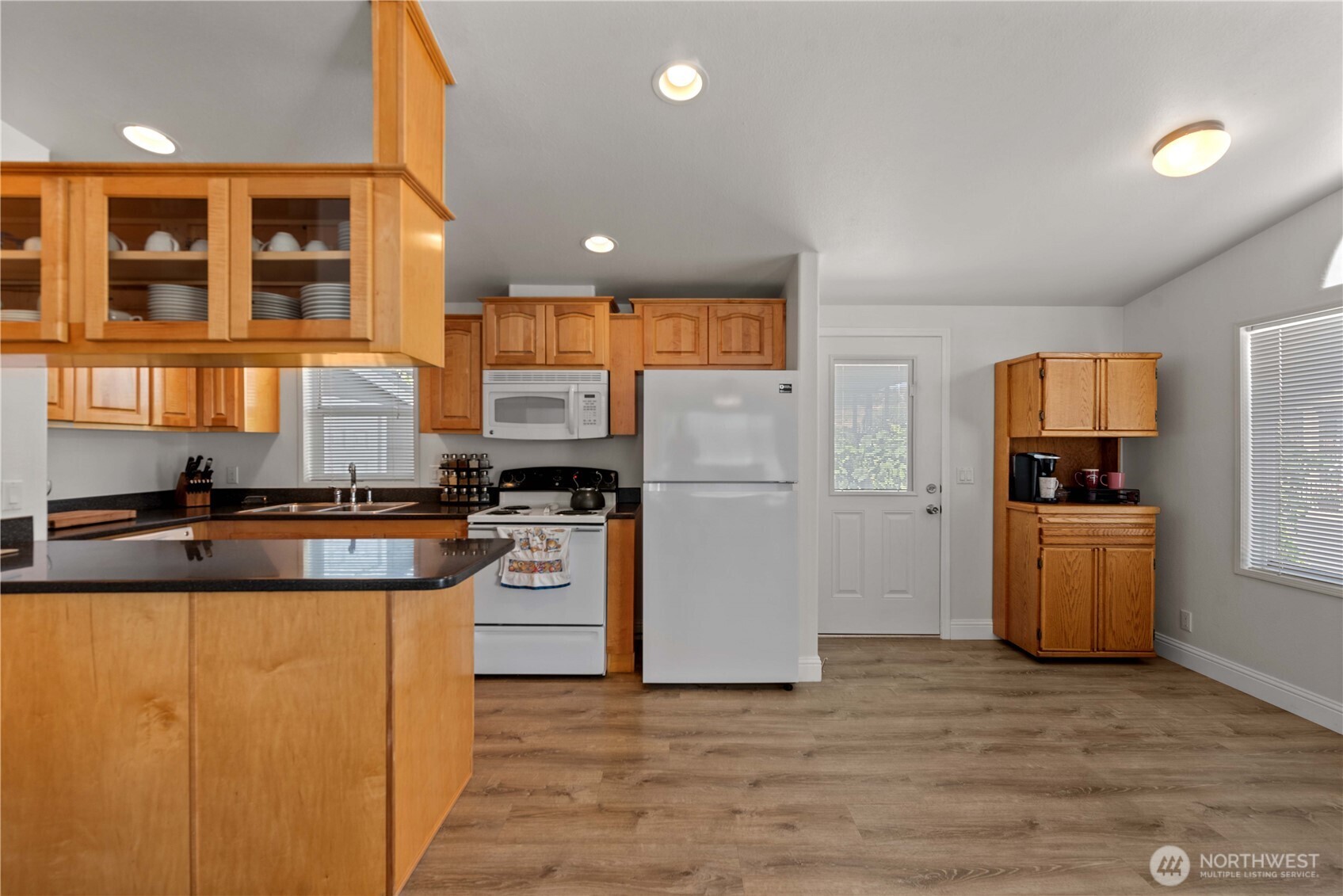 1000 Highway 150, Unit 17 Manson, WA 98831 - Photo 7 of 15 a kitchen with a refrigerator and a stove top oven