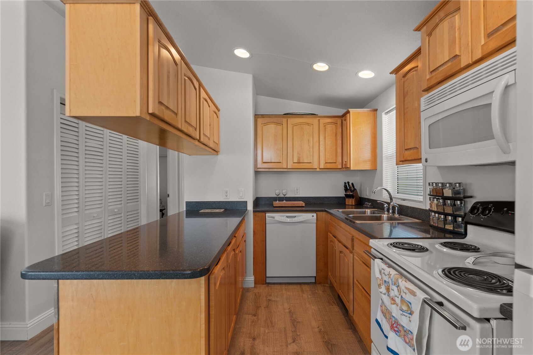 1000 Highway 150, Unit 17 Manson, WA 98831 - Photo 8 of 15 a kitchen with stainless steel appliances granite countertop a sink stove and refrigerator