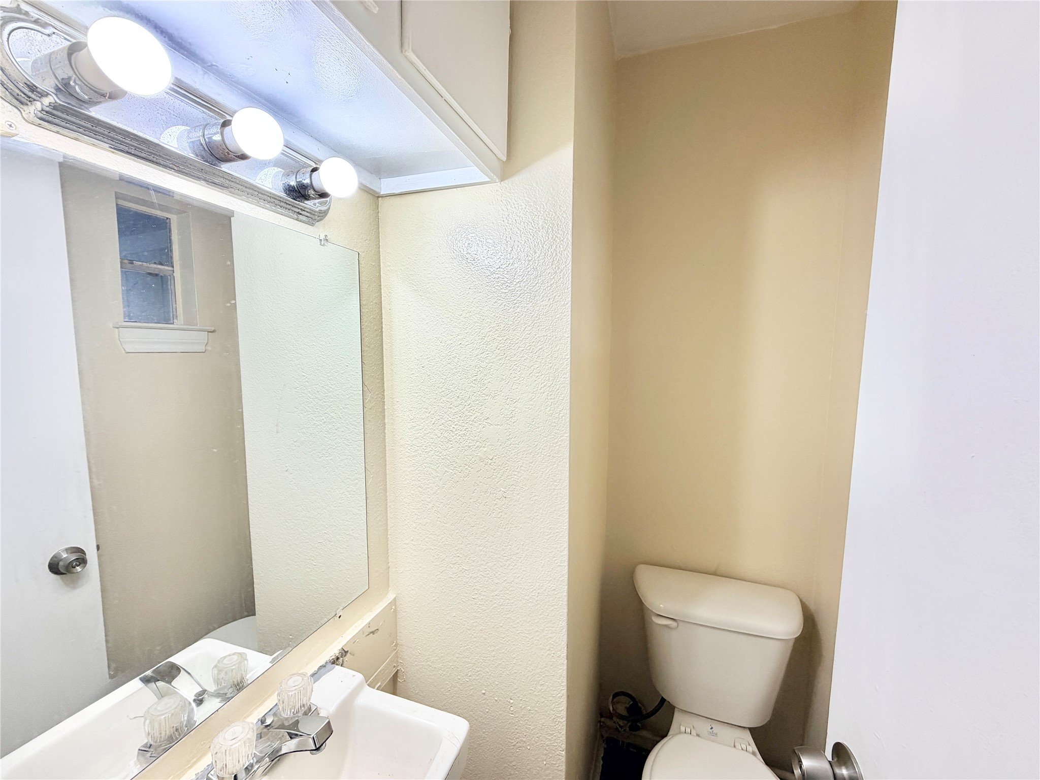 6257 Manor Road, Unit B Austin, TX 78723 - Photo 3 of 38 Bathroom featuring a vanity with an integrated sink, chrome faucet, and a wall-mounted mirror
