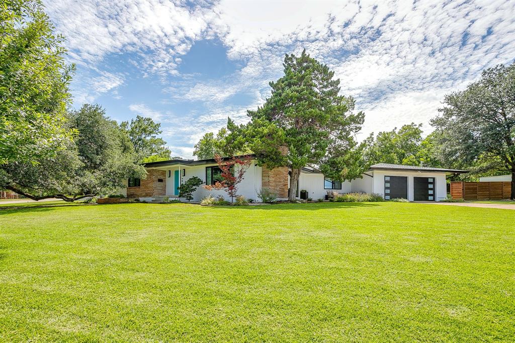6700 Fortune Road Fort Worth, TX 76116 - Photo 1 of 40 Expansive front lawn with mature trees and a contemporary single-story residence