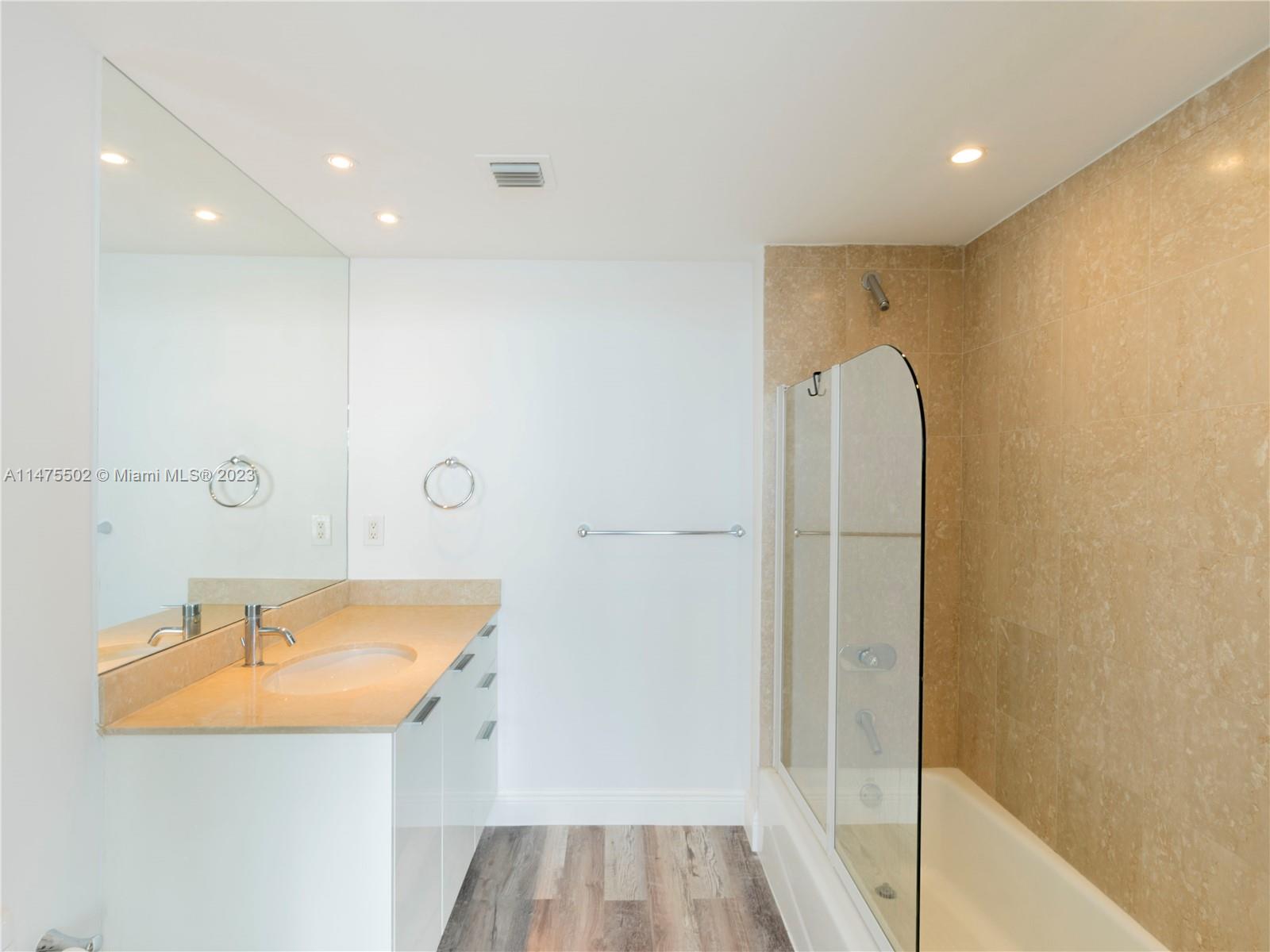 400 Alton Road, Unit 1104 Miami Beach, FL 33139 - Photo 15 of 27 a bathroom with a sink and a mirror