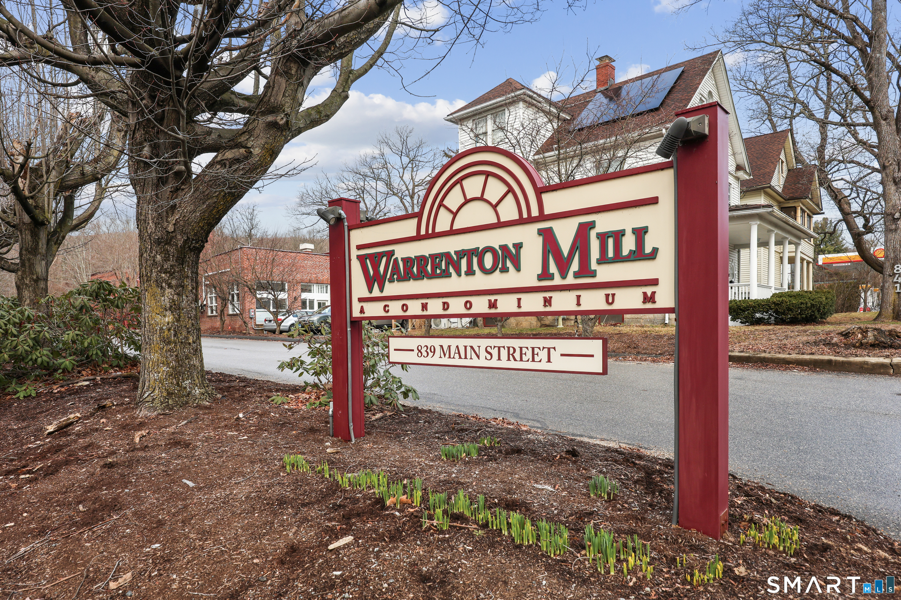 839 Main Street, Unit 73 Torrington, CT 06790 - Photo 1 of 22 a sign on a pole on a street