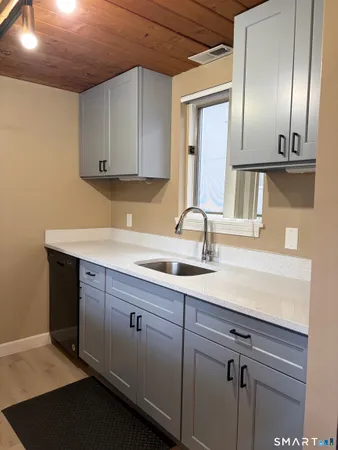a kitchen with a stove cabinets and microwave