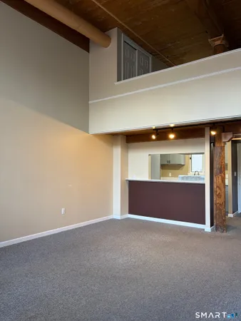 a view of an empty room with window and cabinet