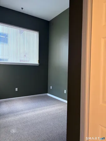 a bathroom with a sink and mirror with toilet