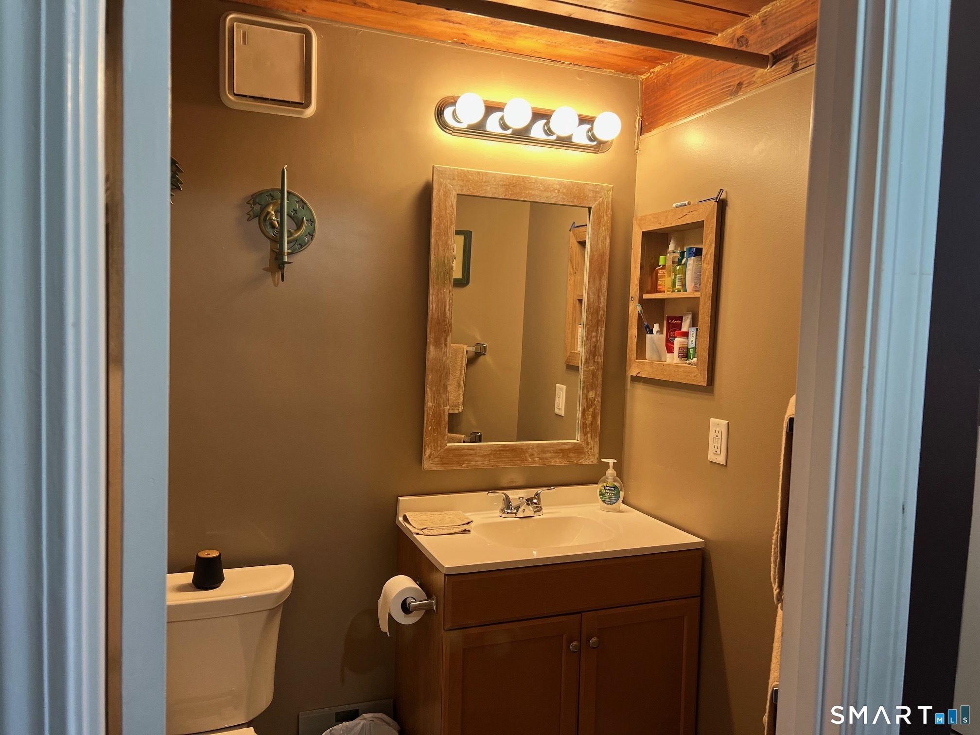 839 Main Street, Unit 73 Torrington, CT 06790 - Photo 21 of 22 a bathroom with a sink and mirror with toilet