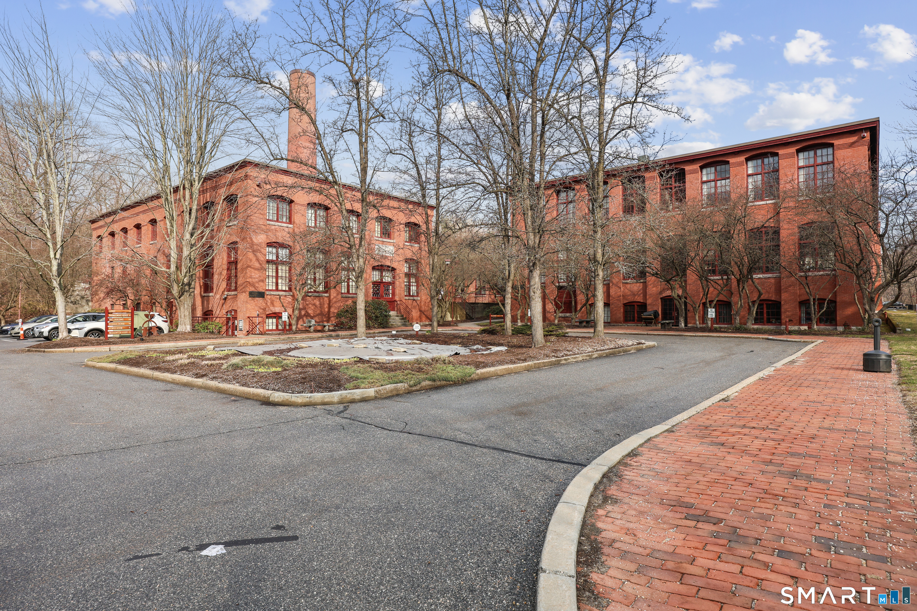 839 Main Street, Unit 73 Torrington, CT 06790 - Photo 3 of 22 a building with trees in front of it