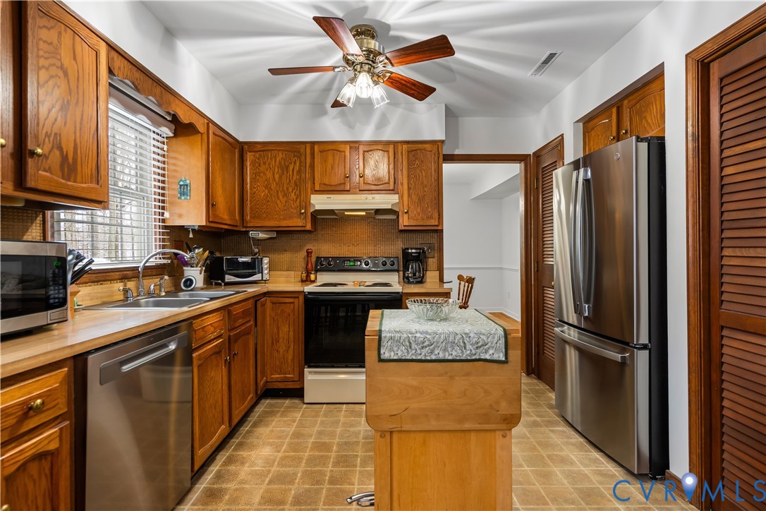 351 Walton Park Road Midlothian, VA 23114 - Photo 17 of 29 Kitchen with light floors, a kitchen island, stain