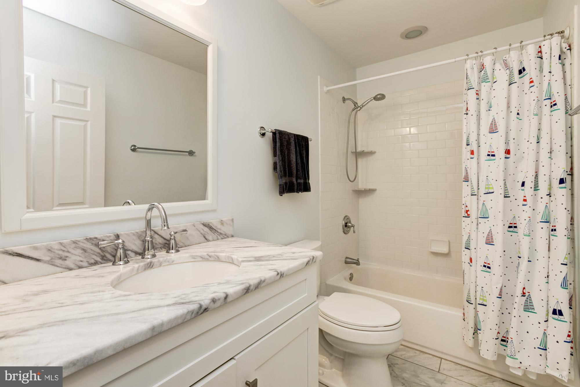 326 Riding Ridge Road Annapolis, MD 21403 - Photo 41 of 63 a bathroom with a granite countertop toilet a sink and a mirror