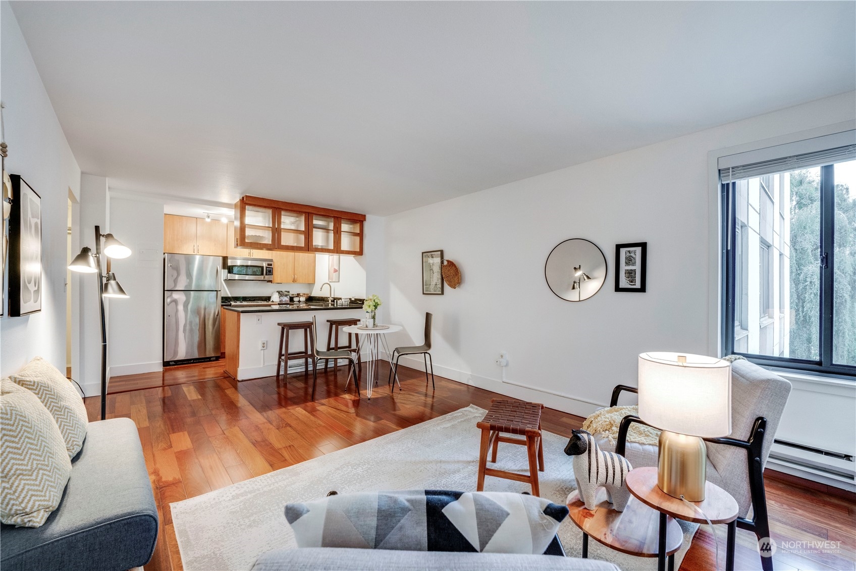 1105 Spring Street, Unit 309 Seattle, WA 98104 - Photo 1 of 39 a living room with furniture and a large window