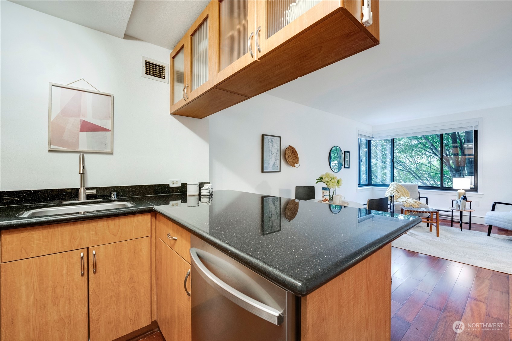 1105 Spring Street, Unit 309 Seattle, WA 98104 - Photo 12 of 39 a open kitchen with stainless steel appliances granite countertop a sink a stove and island
