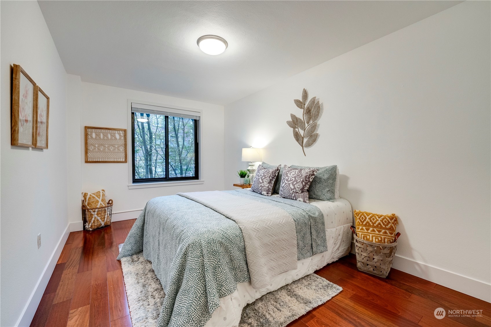 1105 Spring Street, Unit 309 Seattle, WA 98104 - Photo 14 of 39 a bedroom with a bed and wooden floor