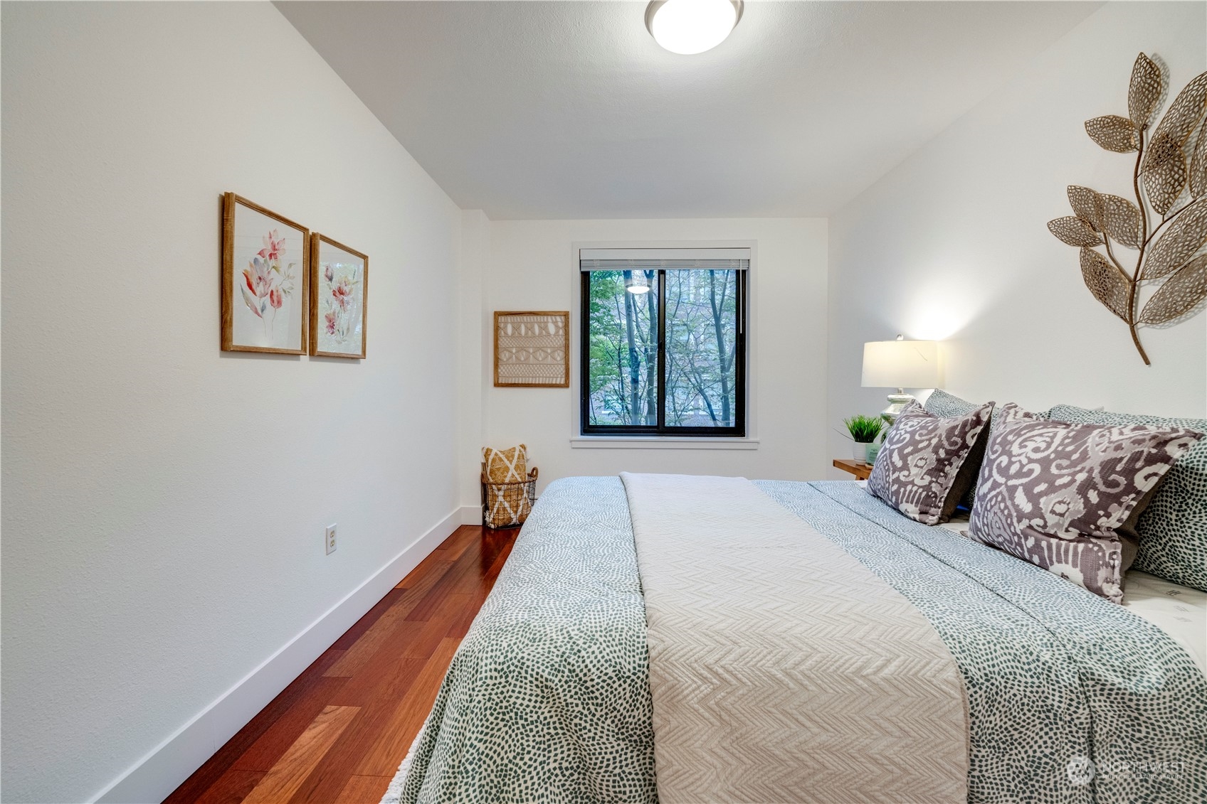 1105 Spring Street, Unit 309 Seattle, WA 98104 - Photo 15 of 39 a bed room with a bed and a painting on the wall