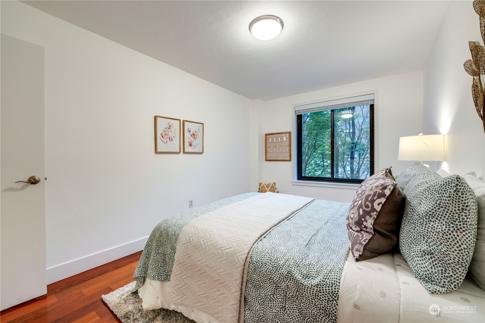1105 Spring Street, Unit 309 Seattle, WA 98104 - Photo 16 of 39 a bedroom with a large bed and a window