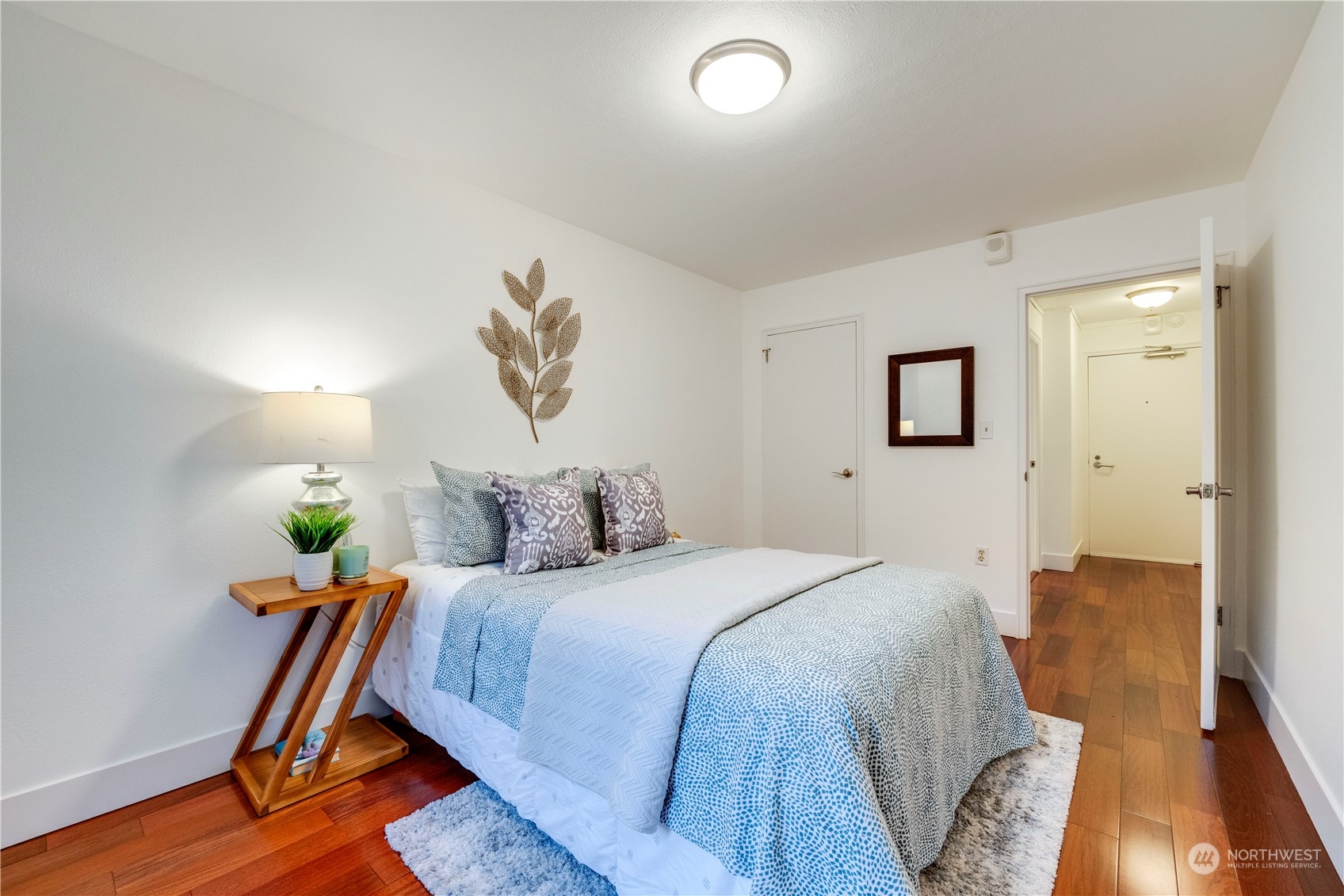 1105 Spring Street, Unit 309 Seattle, WA 98104 - Photo 17 of 39 a bedroom with bed and wooden floor