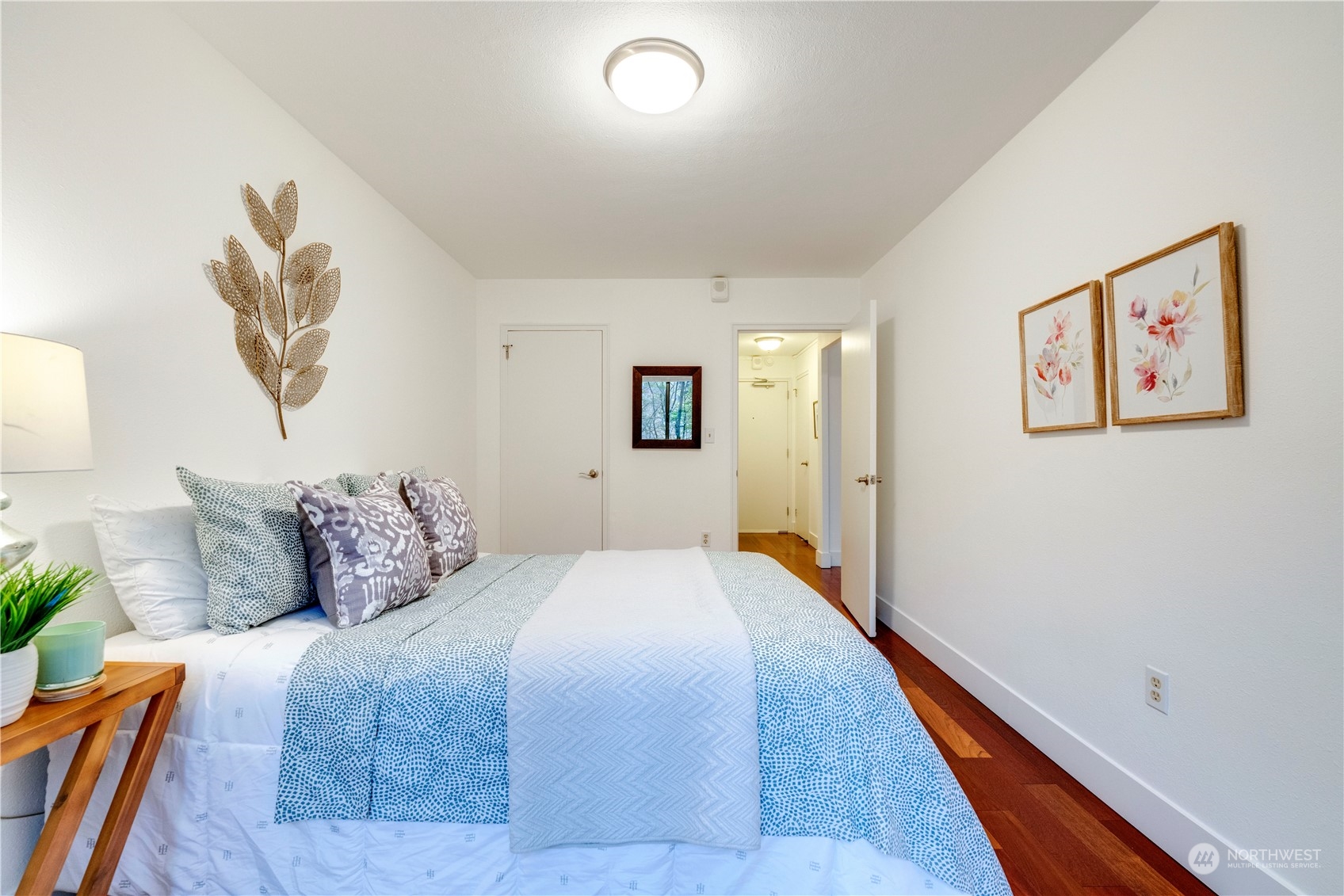 1105 Spring Street, Unit 309 Seattle, WA 98104 - Photo 18 of 39 a bedroom with bed and painting on the wall