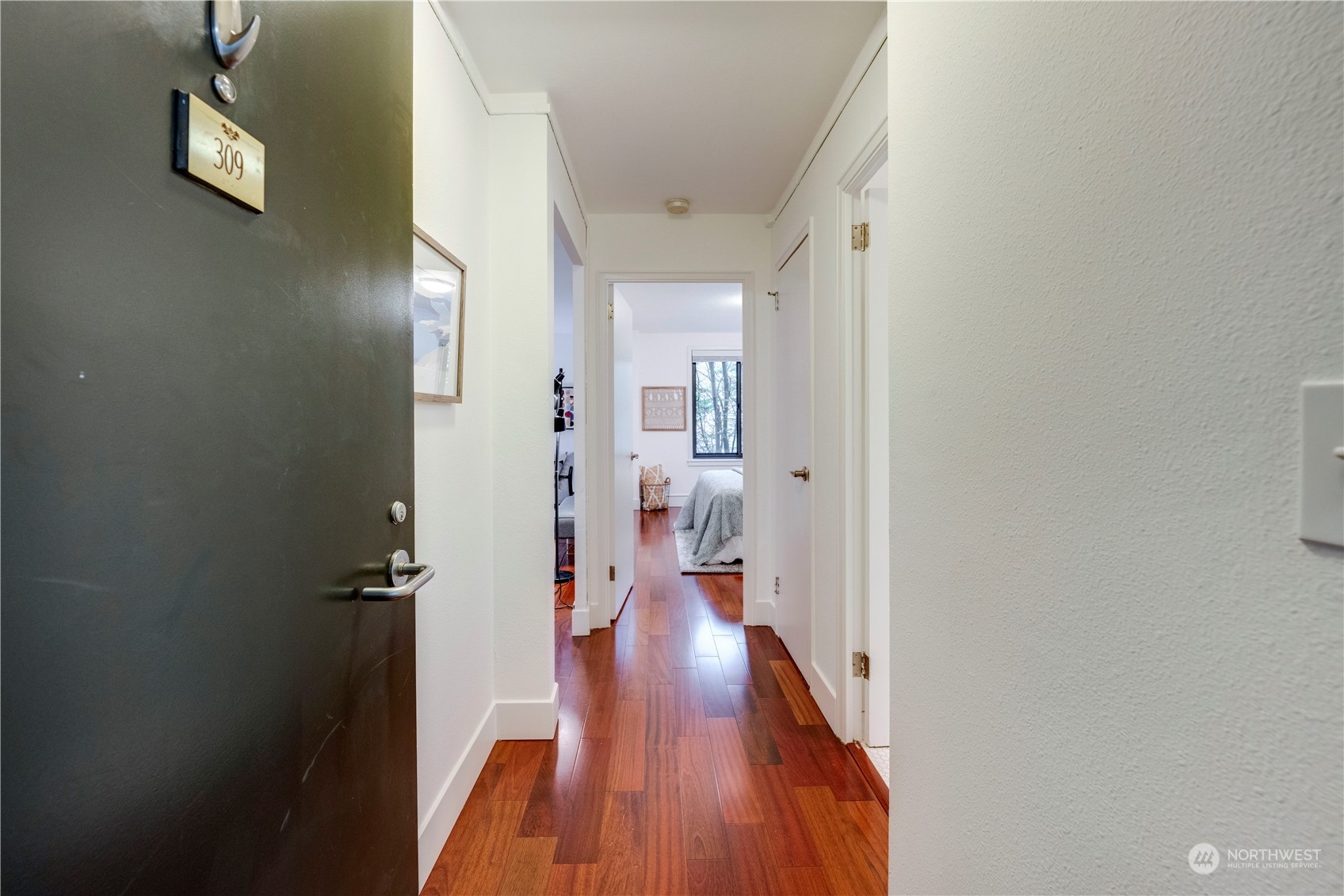 1105 Spring Street, Unit 309 Seattle, WA 98104 - Photo 2 of 39 a view of a hallway with wooden floor