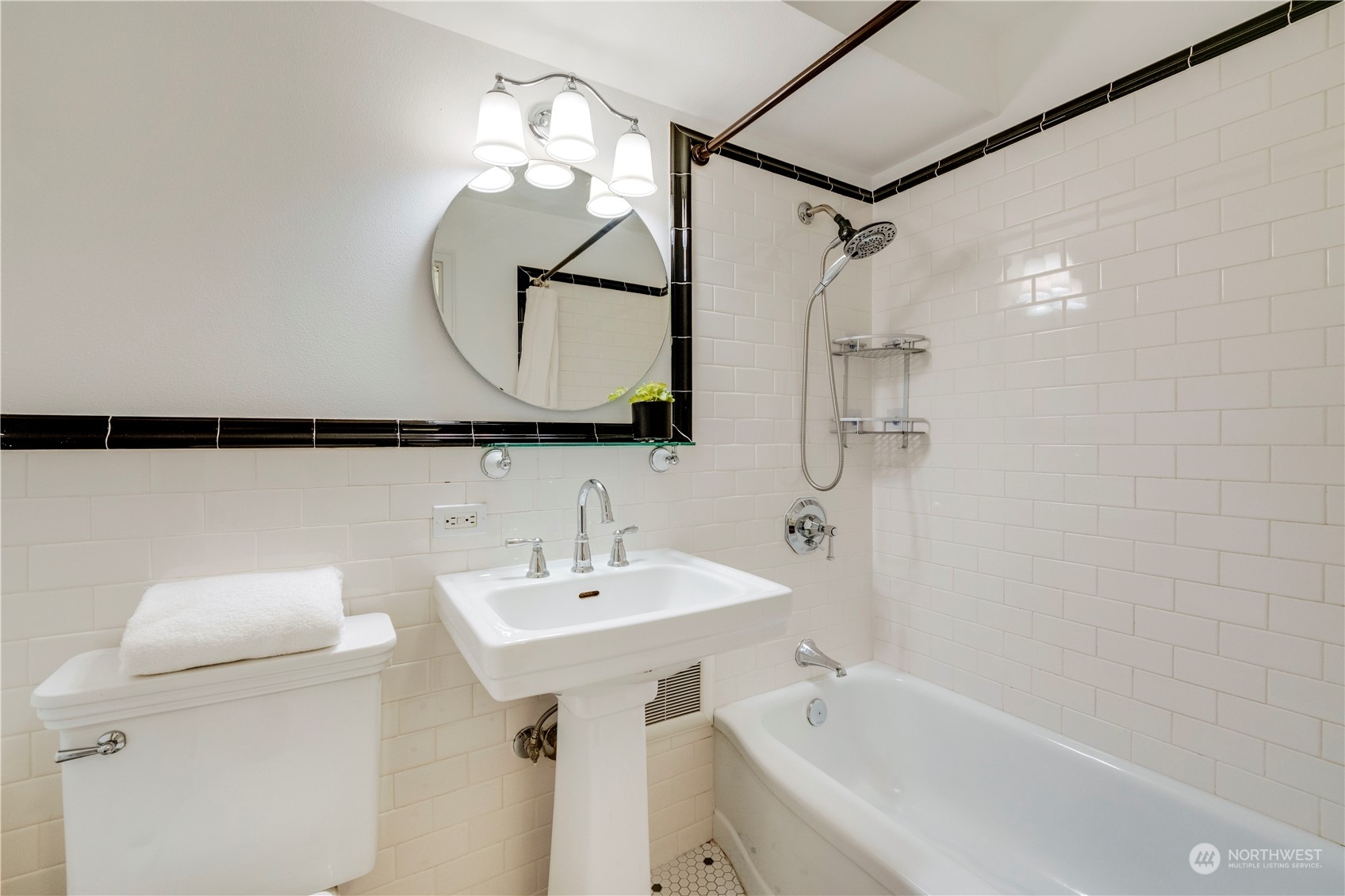 1105 Spring Street, Unit 309 Seattle, WA 98104 - Photo 21 of 39 a bathroom with a sink and a mirror