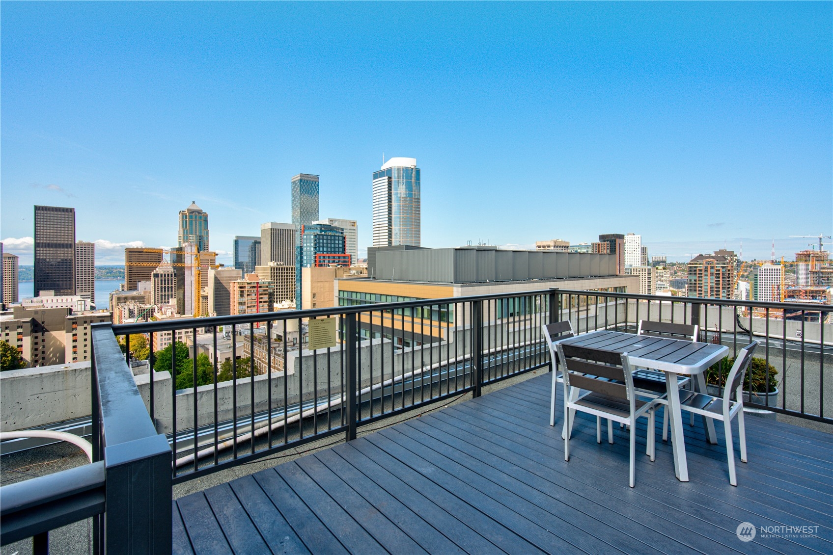 1105 Spring Street, Unit 309 Seattle, WA 98104 - Photo 26 of 39 a view of a roof deck with table and chairs