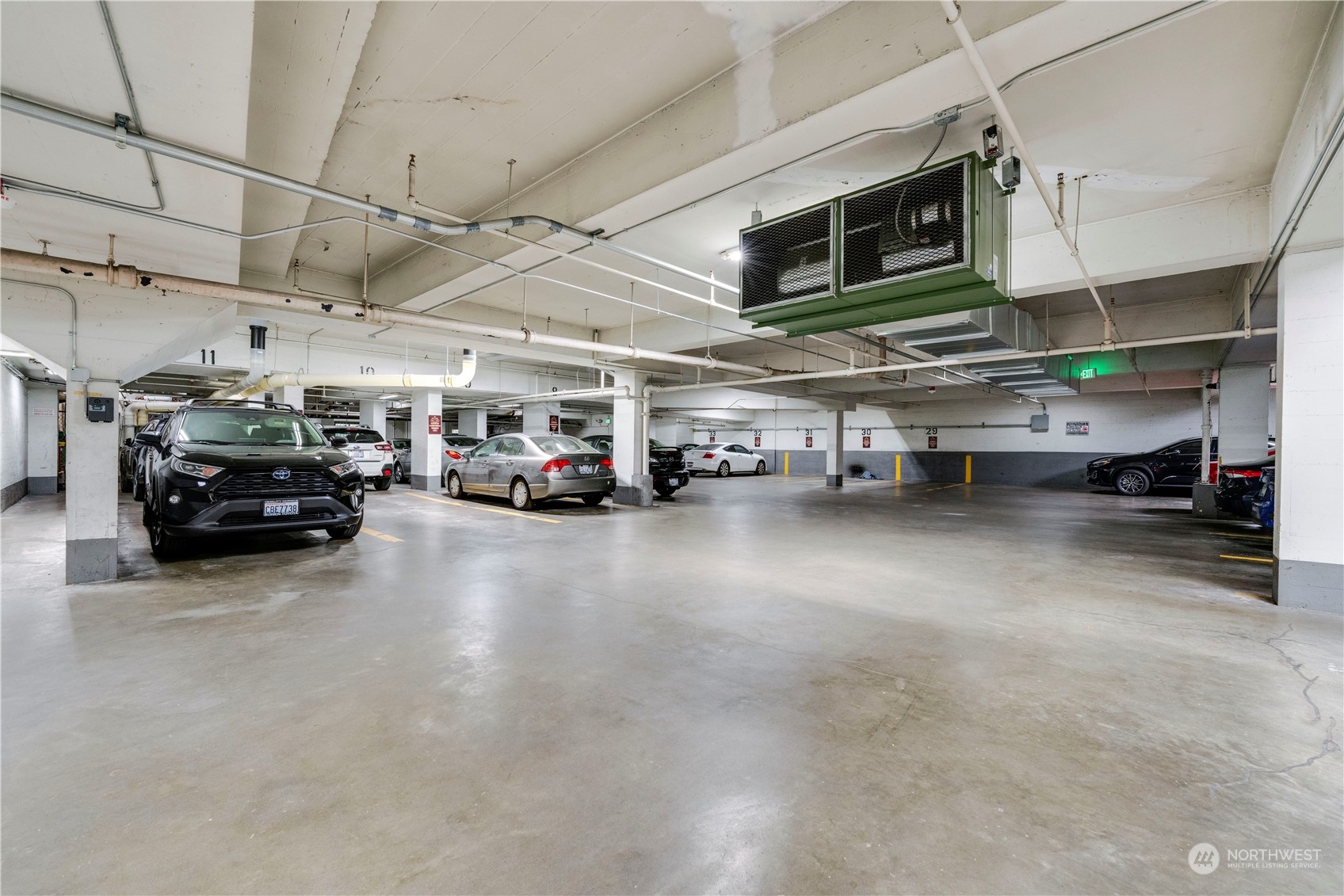 1105 Spring Street, Unit 309 Seattle, WA 98104 - Photo 34 of 39 a view of parking area with parked car