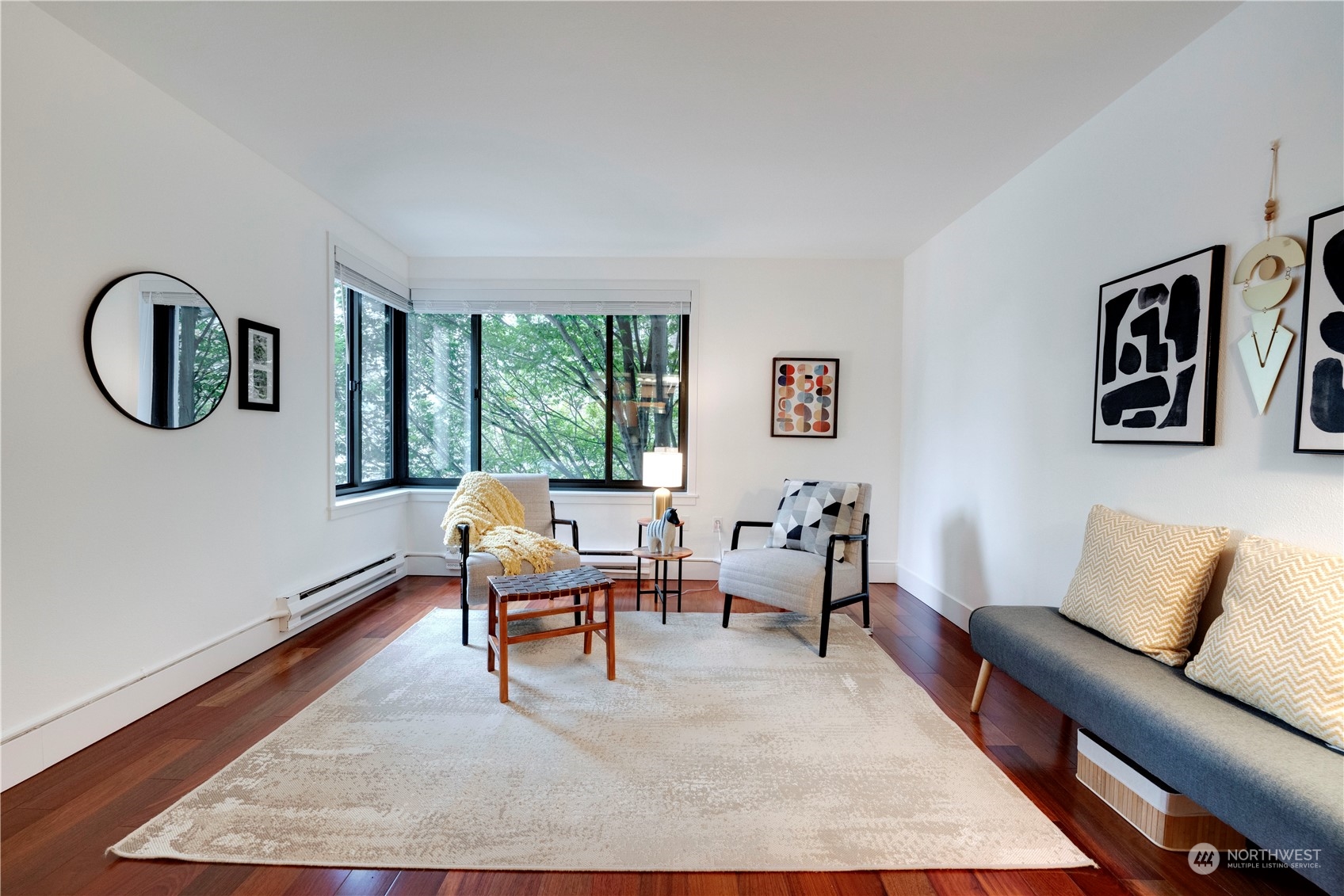 1105 Spring Street, Unit 309 Seattle, WA 98104 - Photo 7 of 39 a living room with furniture and a large window