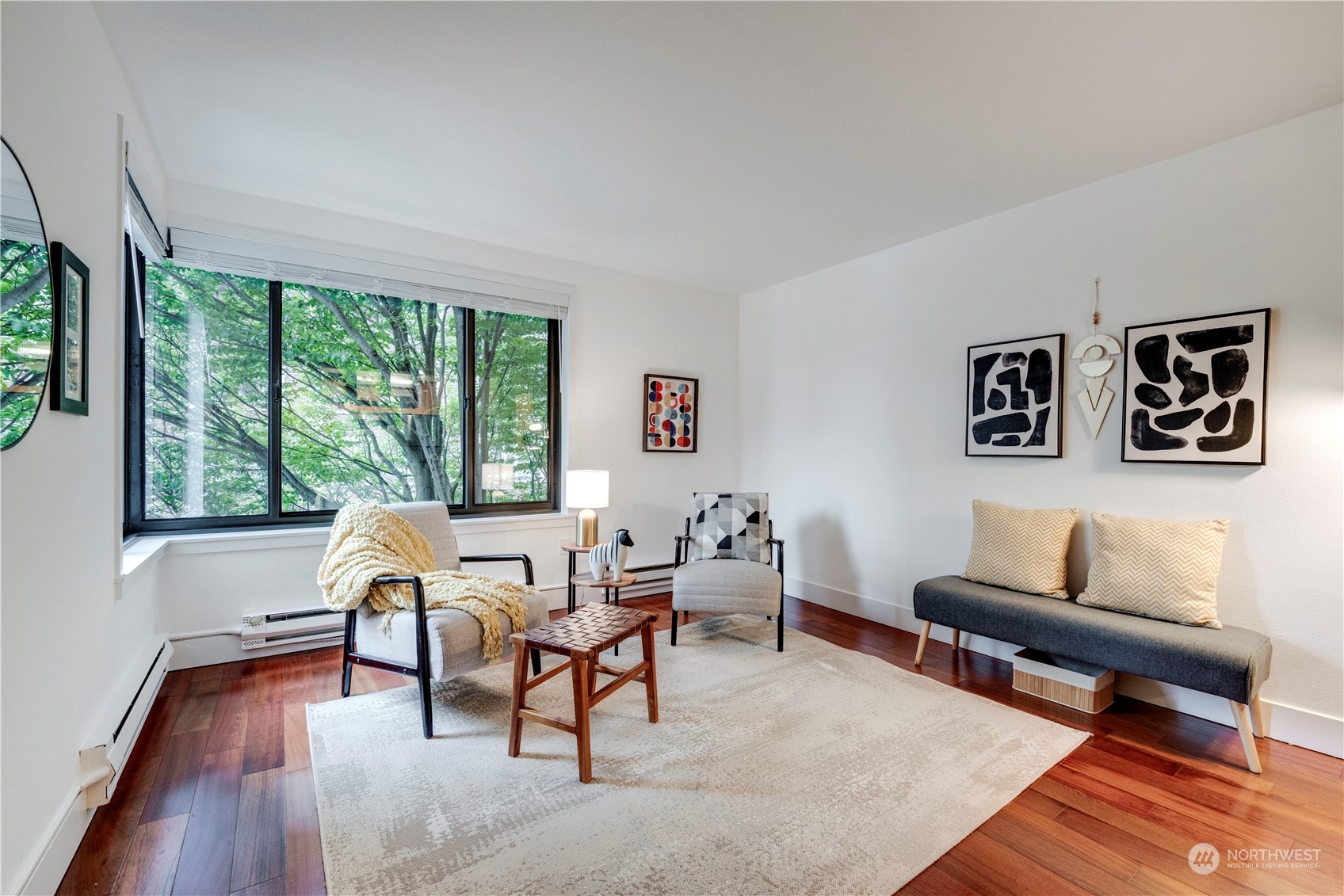 1105 Spring Street, Unit 309 Seattle, WA 98104 - Photo 8 of 39 a living room with furniture and a large window