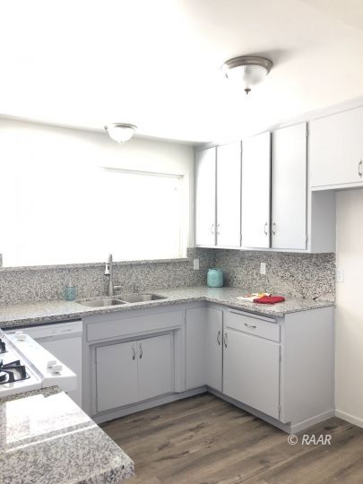 303 West Howell Avenue Ridgecrest, CA 93555 - Photo 4 of 22 a kitchen with a sink cabinets and window