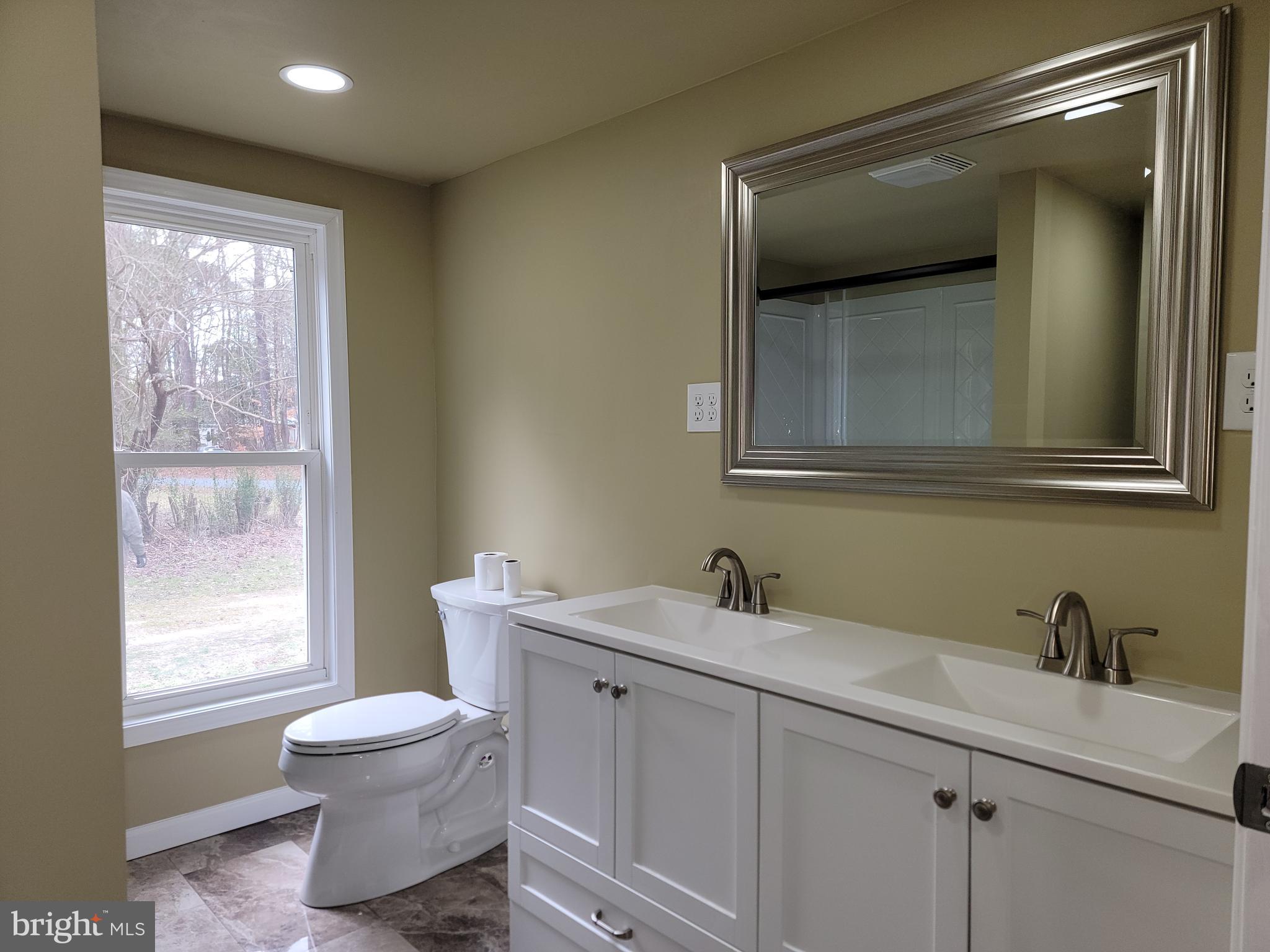 5047 Back Shelltown Road Marion Station, MD 21838 - Photo 14 of 20 a bathroom with a toilet sink and mirror
