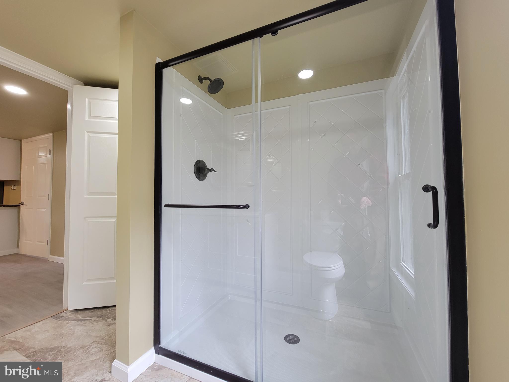 5047 Back Shelltown Road Marion Station, MD 21838 - Photo 15 of 20 a bathroom with a glass shower door