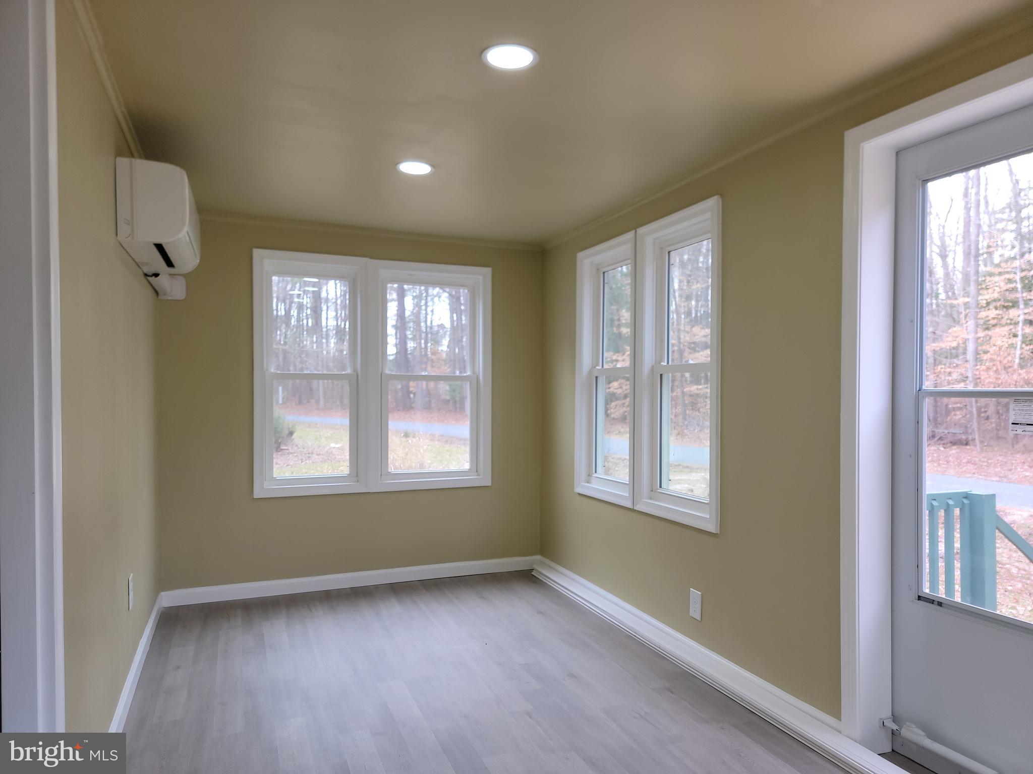 5047 Back Shelltown Road Marion Station, MD 21838 - Photo 2 of 20 a view of an empty room with wooden floor and a window