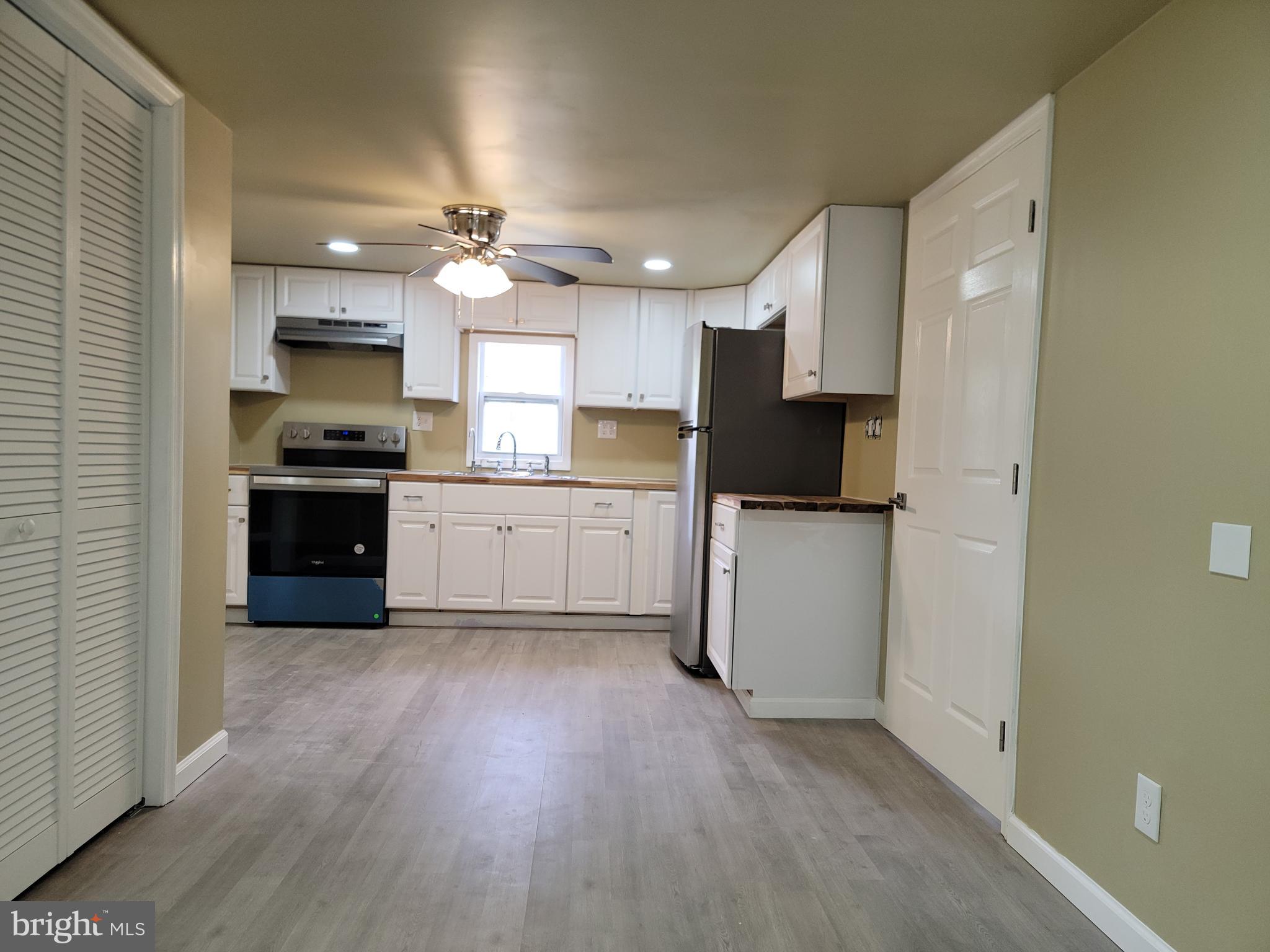 5047 Back Shelltown Road Marion Station, MD 21838 - Photo 8 of 20 a kitchen with granite countertop a refrigerator oven a sink and dishwasher