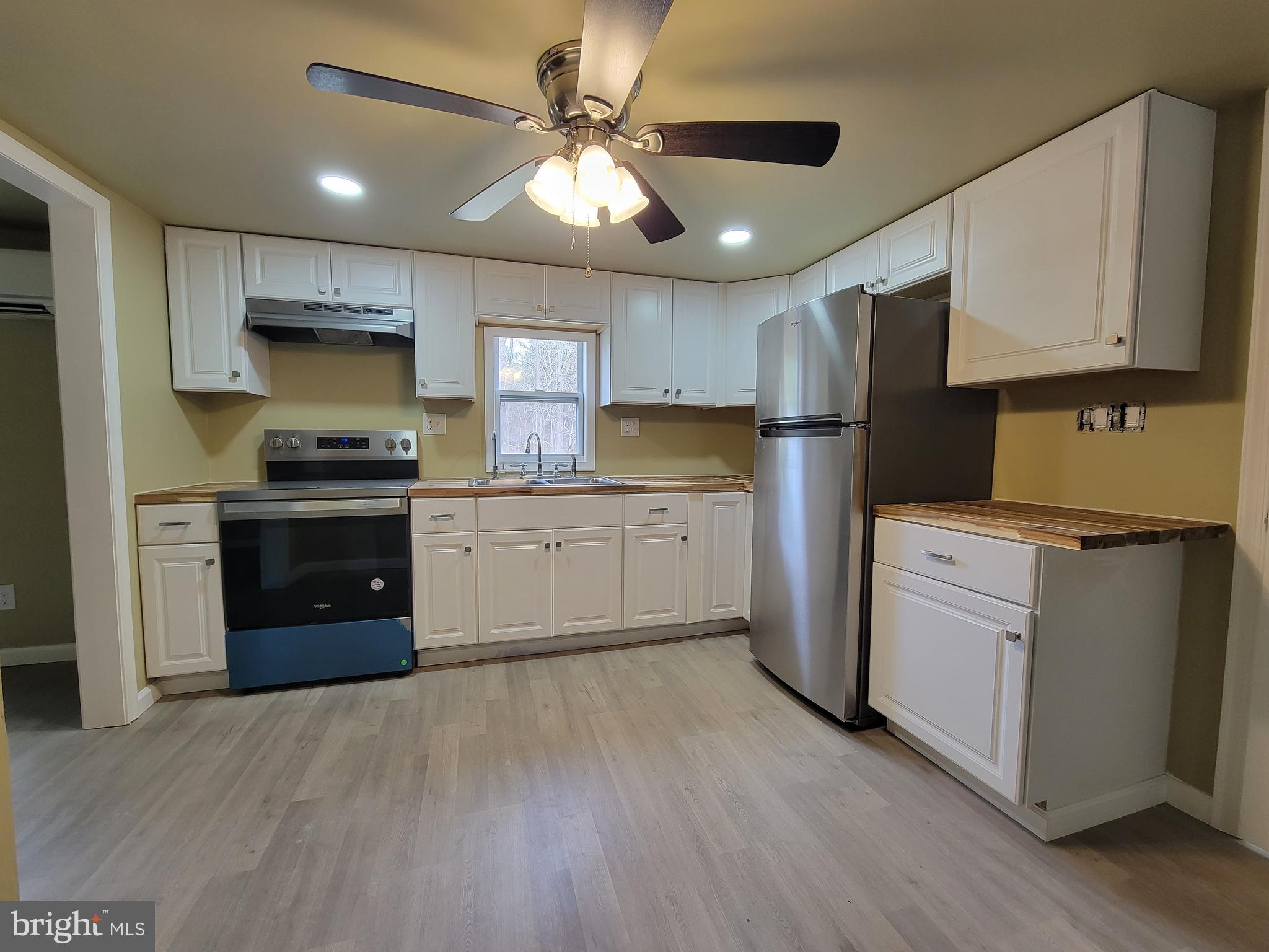 5047 Back Shelltown Road Marion Station, MD 21838 - Photo 10 of 20 a kitchen with a stove a sink and a refrigerator