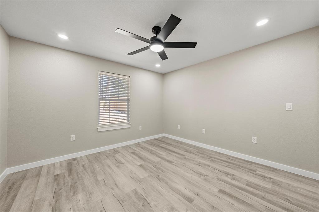 2509 Stewart Drive Waco, TX 76708 - Photo 11 of 17 wooden floor in an empty room with a window