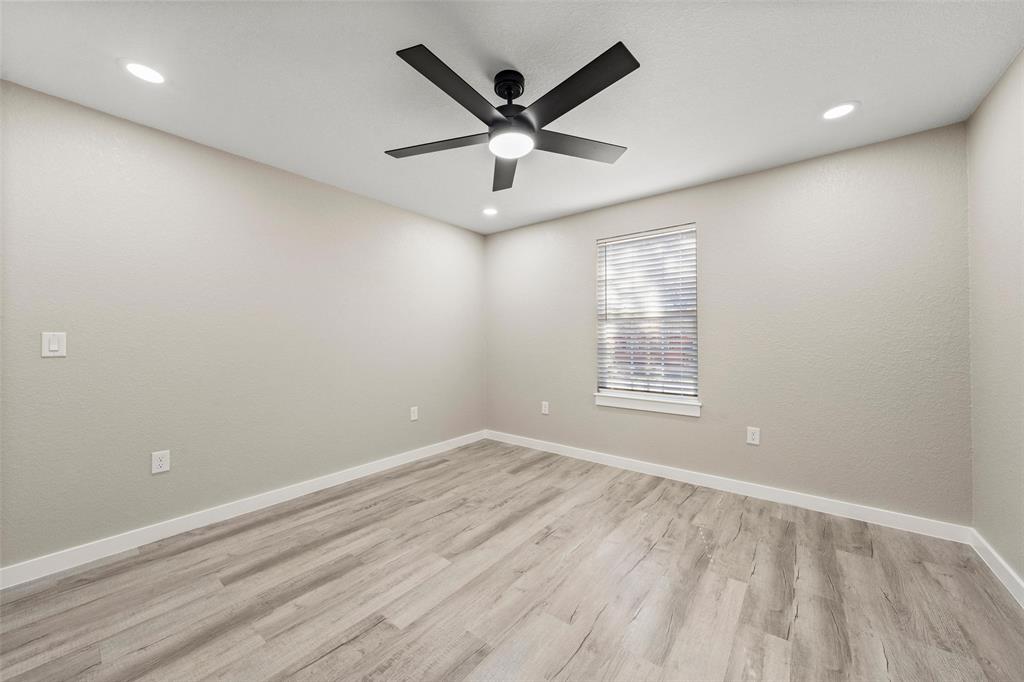 2509 Stewart Drive Waco, TX 76708 - Photo 13 of 17 an empty room with ceiling fan and window
