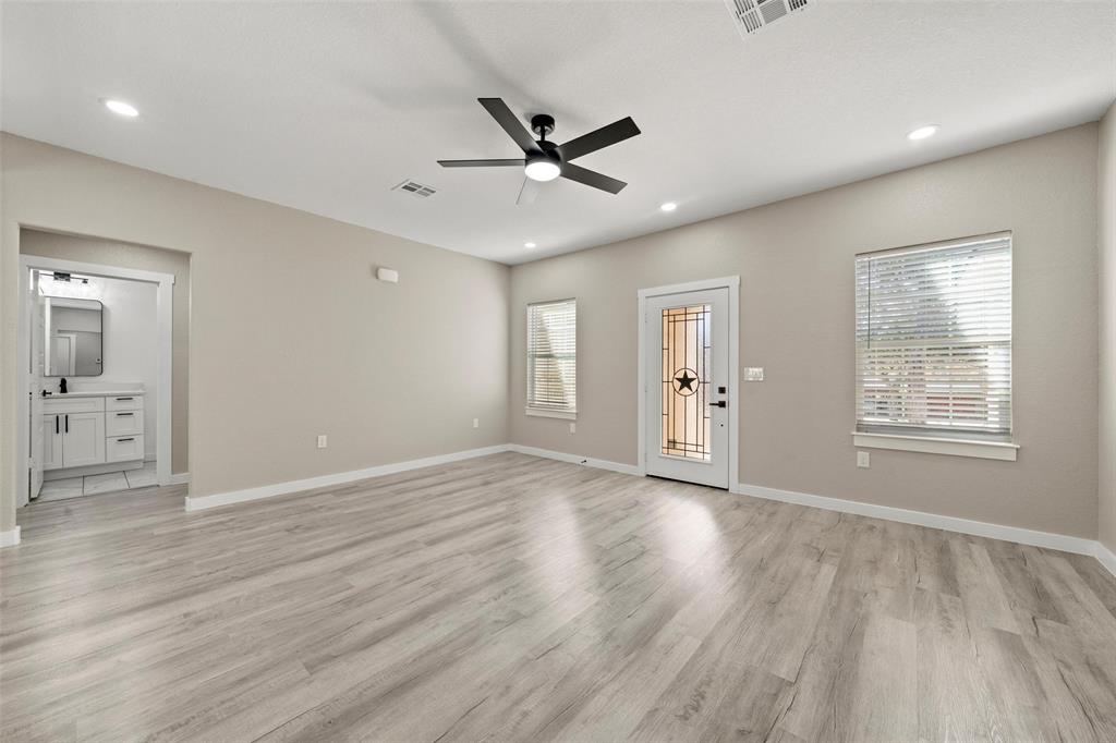 2509 Stewart Drive Waco, TX 76708 - Photo 2 of 17 a view of an empty room with wooden floor and a window