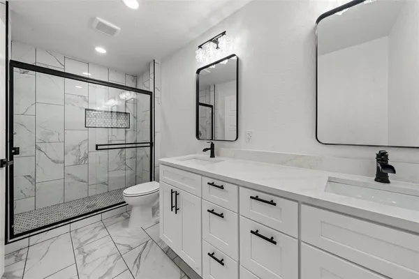 a bathroom with a toilet sink and shower
