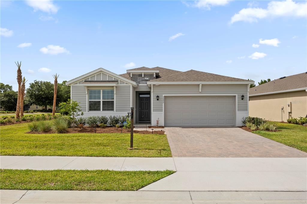 4892 Northwest 39th Loop Ocala, FL 34482 - Photo 1 of 1 a front view of a house with a yard and garage