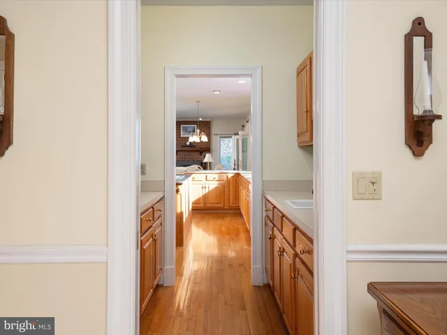 a bathroom with a granite countertop sink and a mirror with toilet