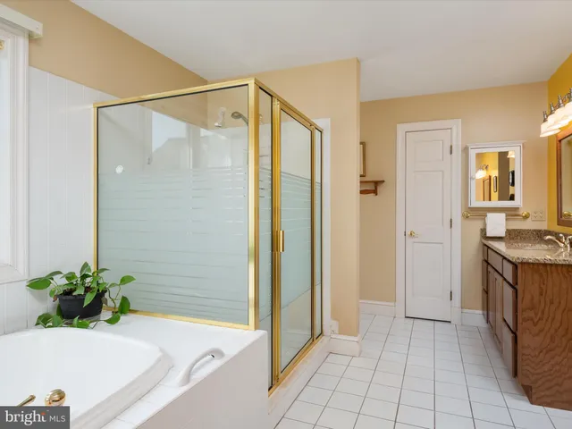 an aerial view of a house with a garden and lake view