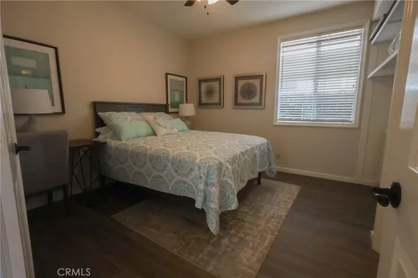 a bed sitting in a bedroom next to a window