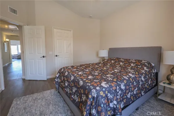 a bed sitting in a bedroom next to a bathroom