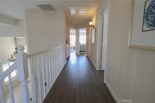 a view of a hallway with wooden floor