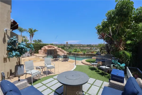 a view of a chairs and table in patio