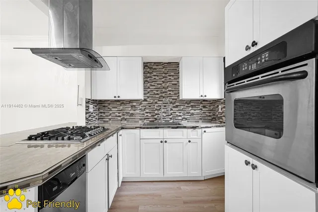 a kitchen with stainless steel appliances granite countertop a sink stove and microwave
