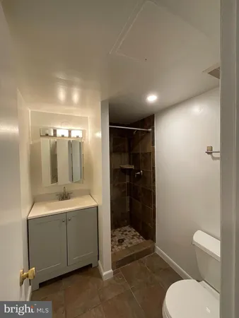 a bathroom with a toilet a sink and shower