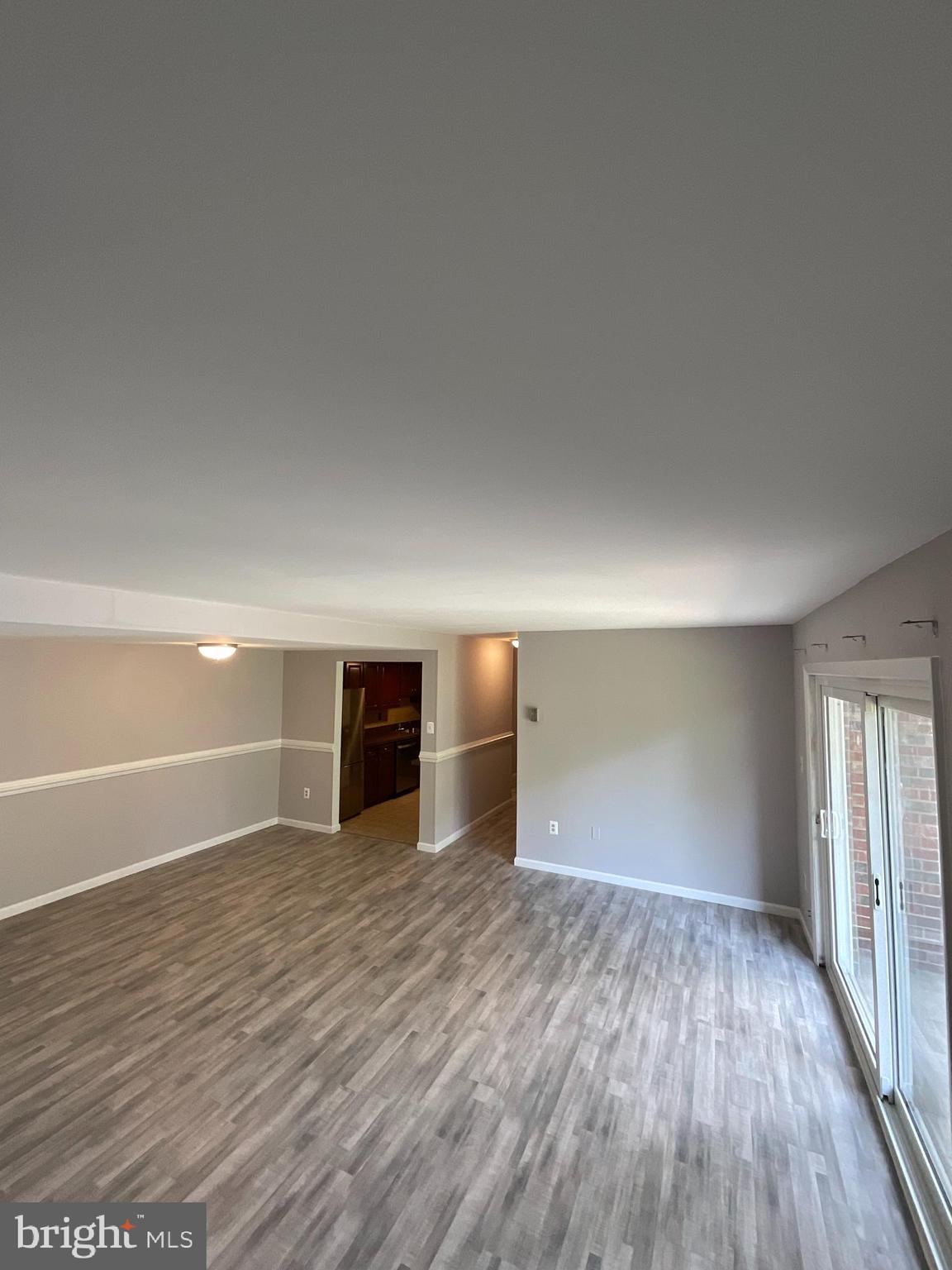 4509 Romlon Street, Unit 102 Beltsville, MD 20705 - Photo 16 of 22 a view of a big room with wooden floor and windows
