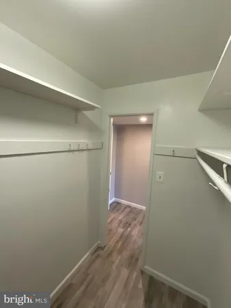 a view of an empty room and wooden floor