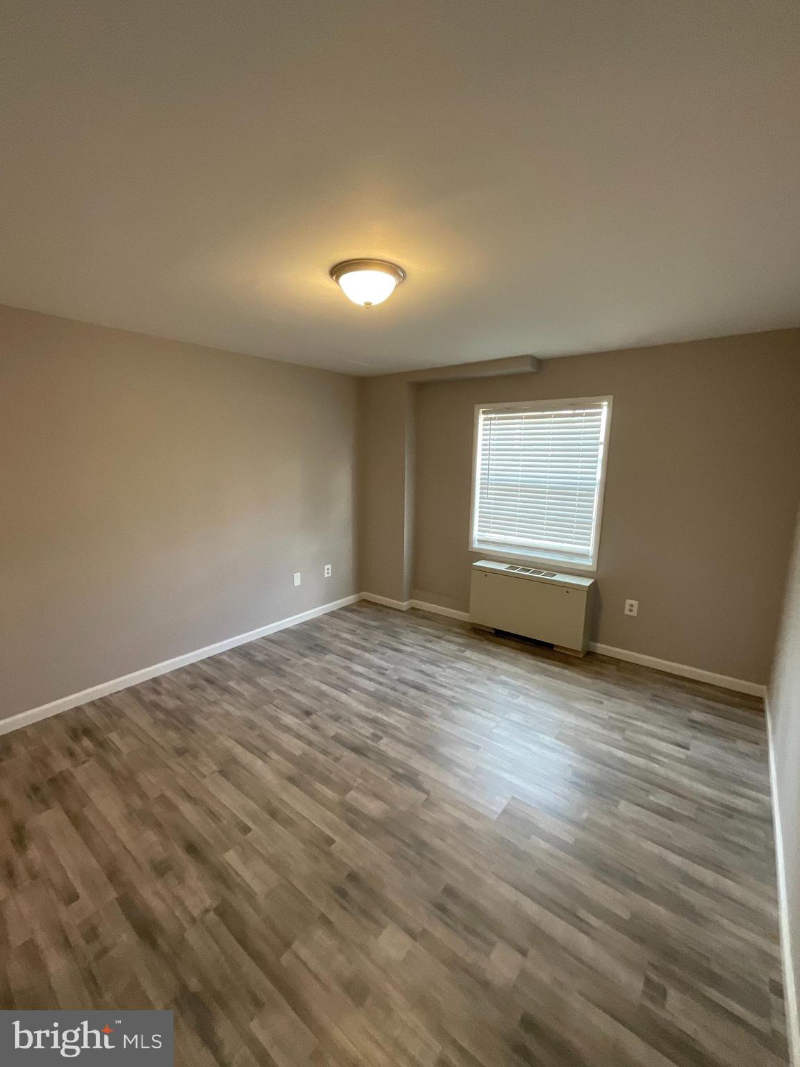 4509 Romlon Street, Unit 102 Beltsville, MD 20705 - Photo 22 of 22 a view of empty room with wooden floor and fan